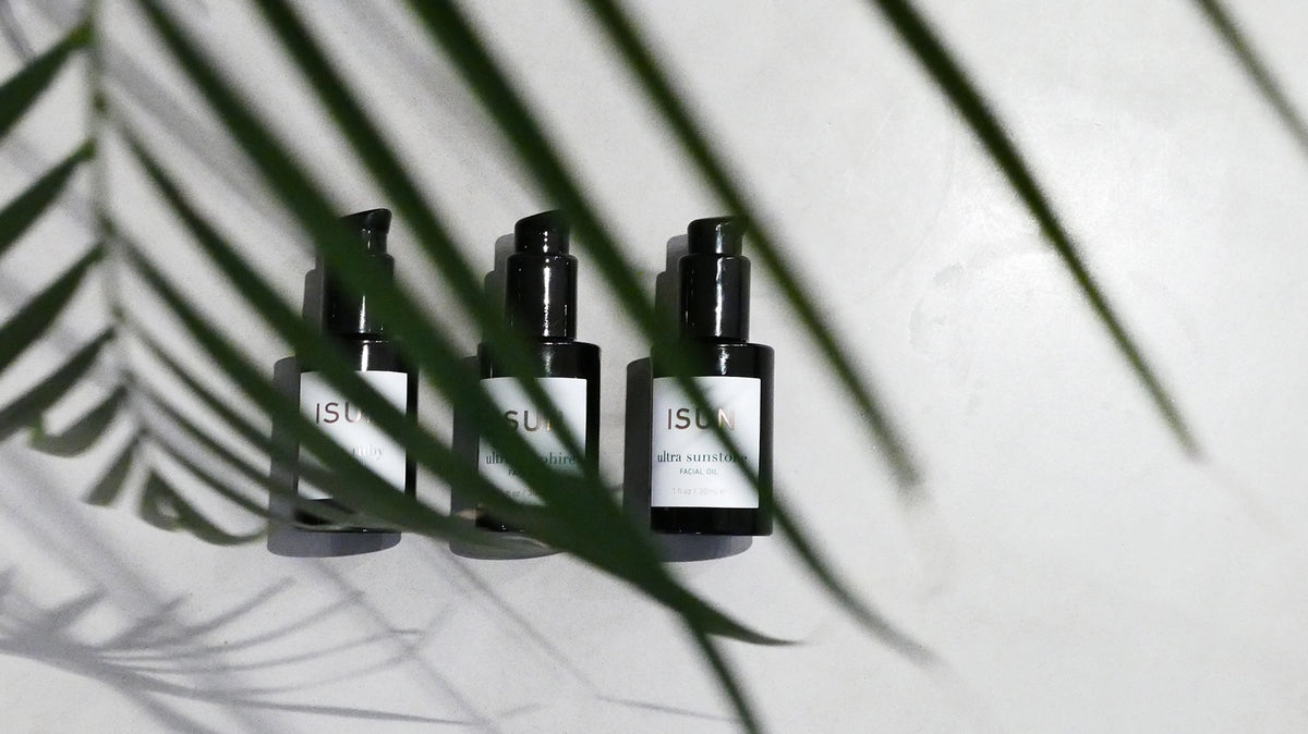ISUN Facial Oil Moisturizers and palm plant reflection