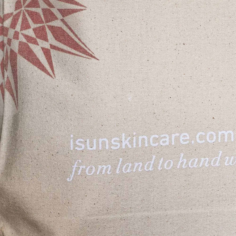 Beige tote bag with rose gold geometric design and white text on a beige background