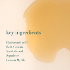 Product with a close-up of a yellowish liquid and text listing key ingredients on a beige background.