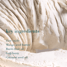 Close-up of a creamy texture with text listing key ingredients.