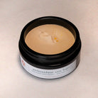 Jar of antioxidant sun butter on a beige background
