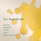 Yellow liquid splashes with text listing key ingredients on a light background