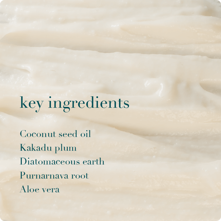 Close-up of a creamy texture with text listing key ingredients on a white background