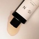 Cosmetic product with ISUN branding on a neutral background