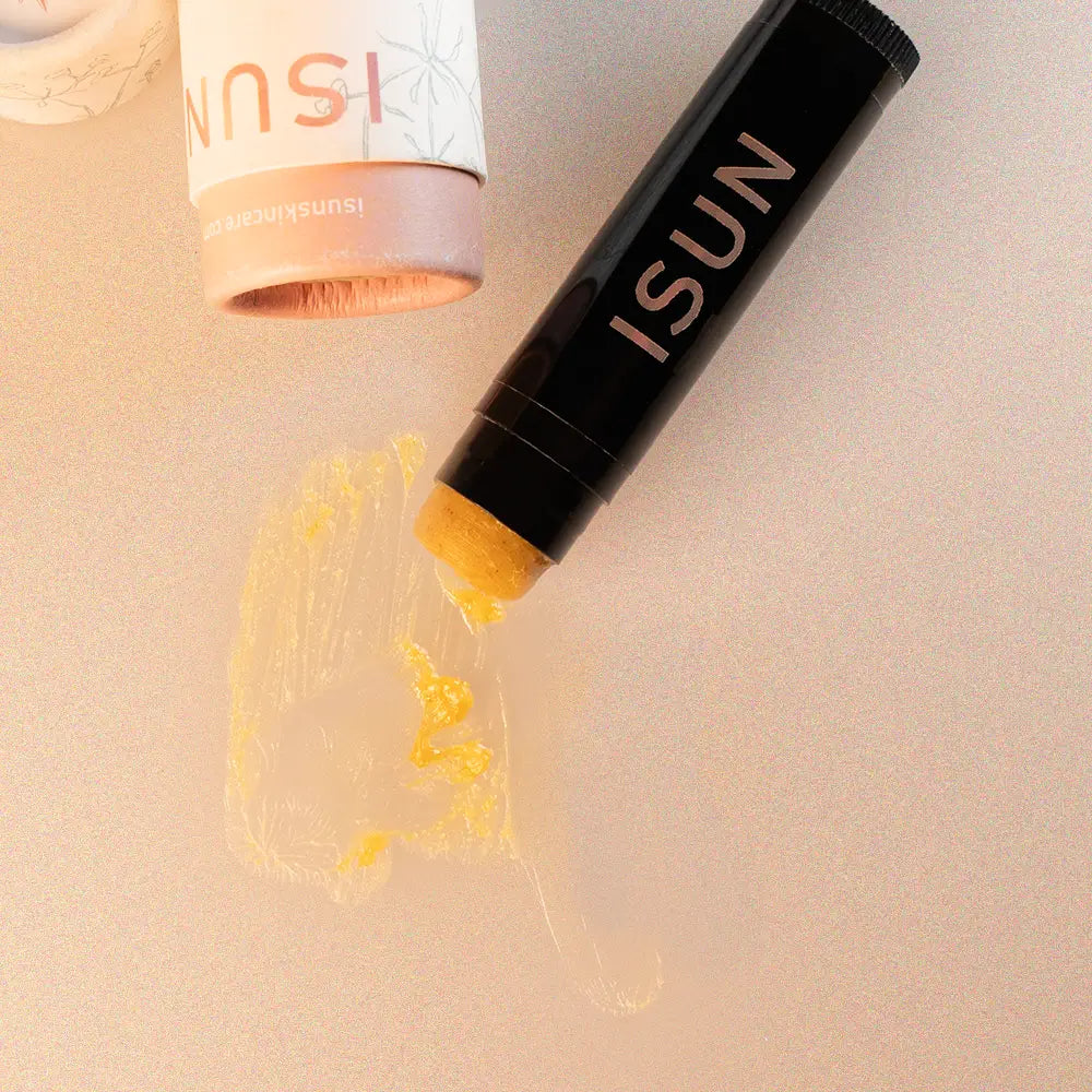 ISUN skincare product with yellow cream on a beige background