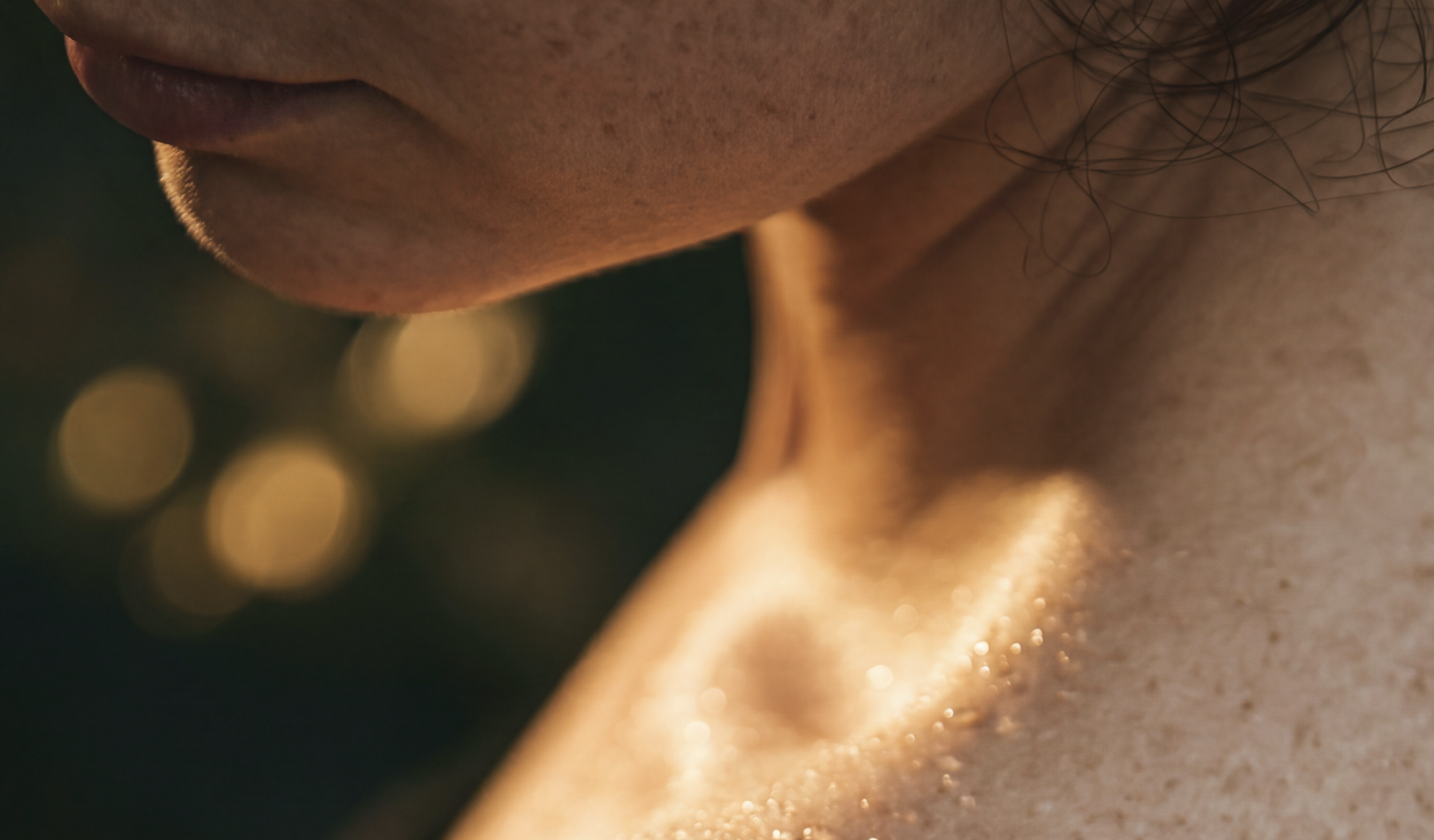Close-up of a person's neck with blurred background