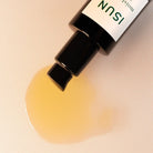 ISUN skincare product being dispensed onto a beige background