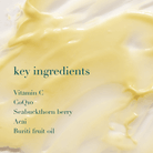 Yellow cream with text listing key ingredients on a white background