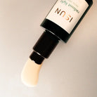 Cosmetic bottle with a pump on a neutral background