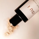 ISU makeup product with a close-up of powder on a light background
