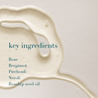Liquid ingredient with text listing key ingredients on a light background
