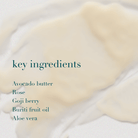 Close-up of a skincare product with text listing key ingredients on a light background