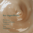 Close-up of a smooth, beige texture with text listing key ingredients.