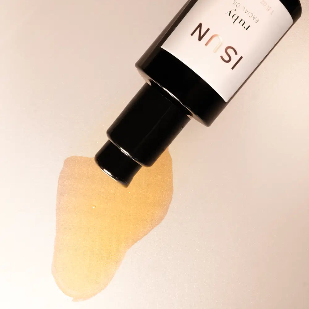 ISUN skincare product with a droplet of cream on a beige background