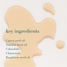 Beige liquid with text listing key ingredients on a light background