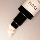 Cosmetic bottle with visible brand name on a neutral background