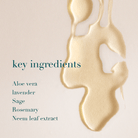 Gold liquid droplet with text listing key ingredients on a beige background