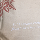 Beige tote bag with rose gold geometric design and white text on a beige background