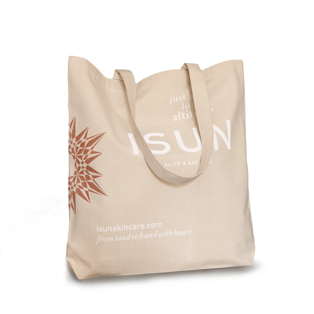 Beige tote bag with branding and text on a white background