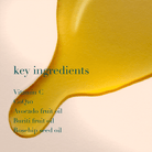 Yellow liquid droplet with text listing key ingredients on a beige background