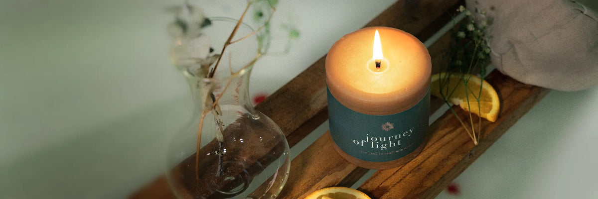 Candle with a blue label on a wooden surface with decorative elements