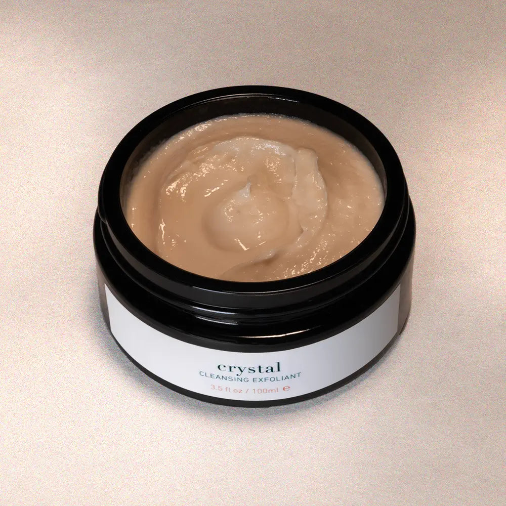 Jar of 'Crystal' cleansing exfoliant on a neutral background
